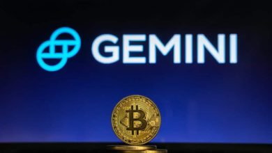 Bitcoin on a stack of coins with Gemini logo on a laptop screen 1024x683 1 Detafour